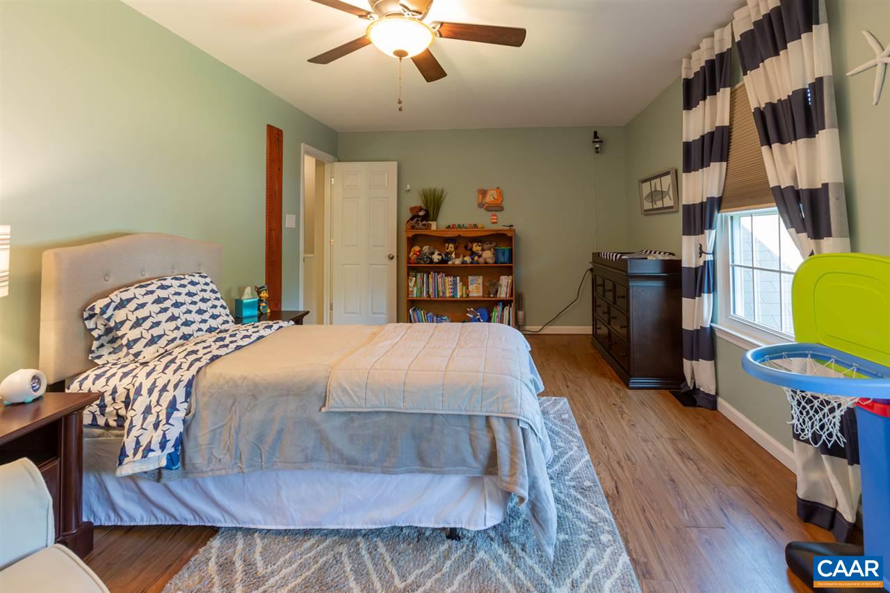 194 Ruckersville Heights Road Ruckersville, VA 22968 - Photo 34 of 38 a bedroom with a bed and wooden floor