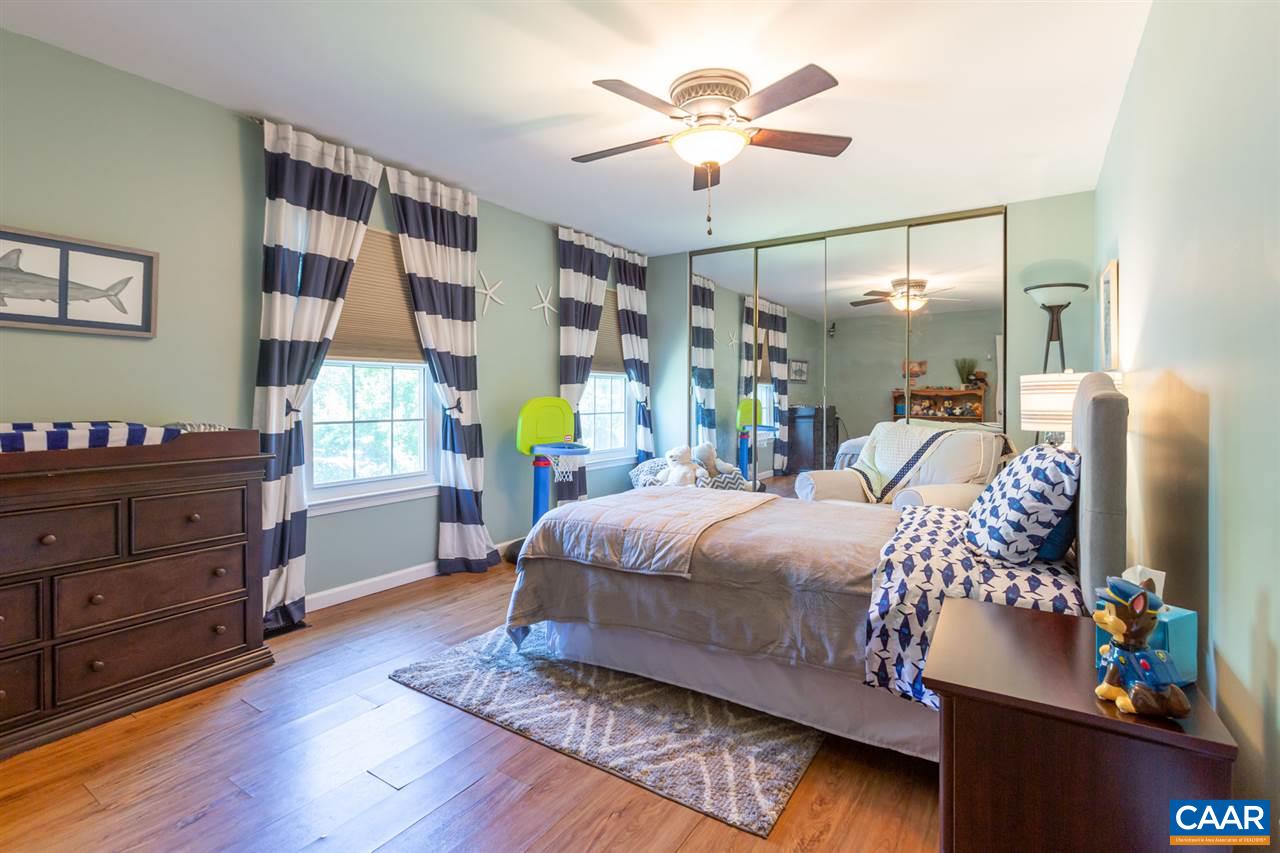 194 Ruckersville Heights Road Ruckersville, VA 22968 - Photo 35 of 38 a bedroom with a bed and wooden floor