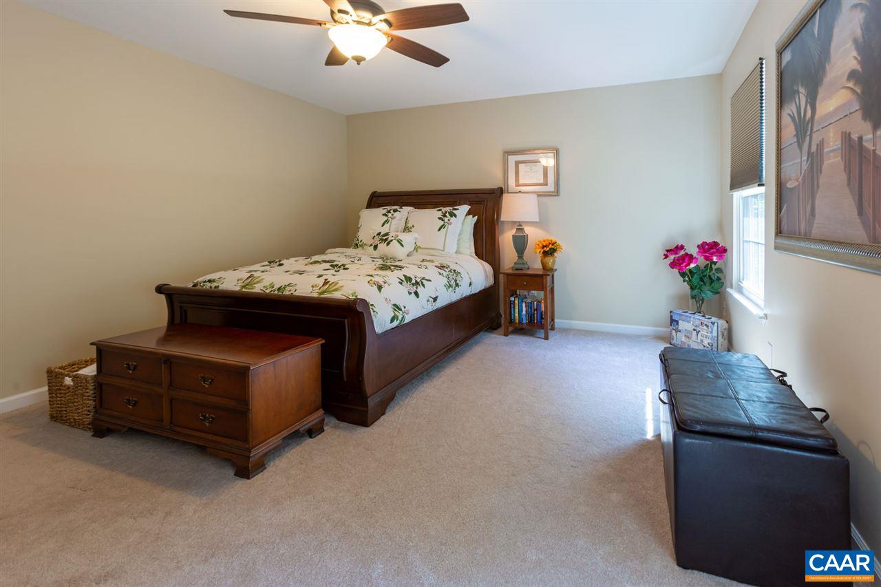 194 Ruckersville Heights Road Ruckersville, VA 22968 - Photo 36 of 38 a bedroom with a bed and a chandelier