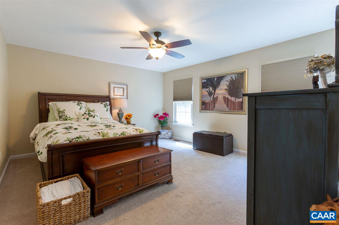 194 Ruckersville Heights Road Ruckersville, VA 22968 - Photo 37 of 38 a bedroom with a bed and a chandelier