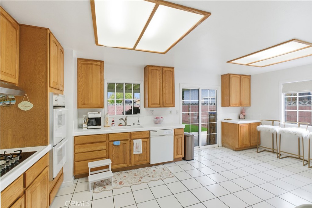 6290 Cynthia Street Simi Valley, CA 93063 - Photo 14 of 32 a large white kitchen with a stove a sink dishwasher and a microwave oven