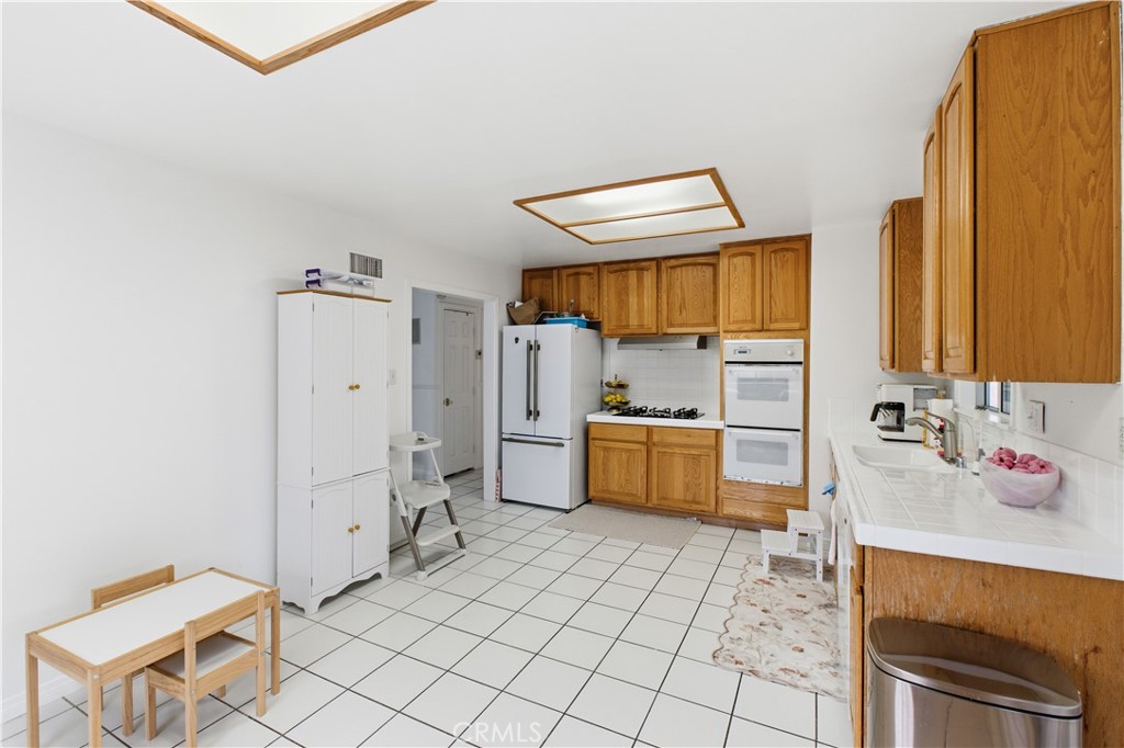 6290 Cynthia Street Simi Valley, CA 93063 - Photo 17 of 32 a kitchen with a cabinets and appliances