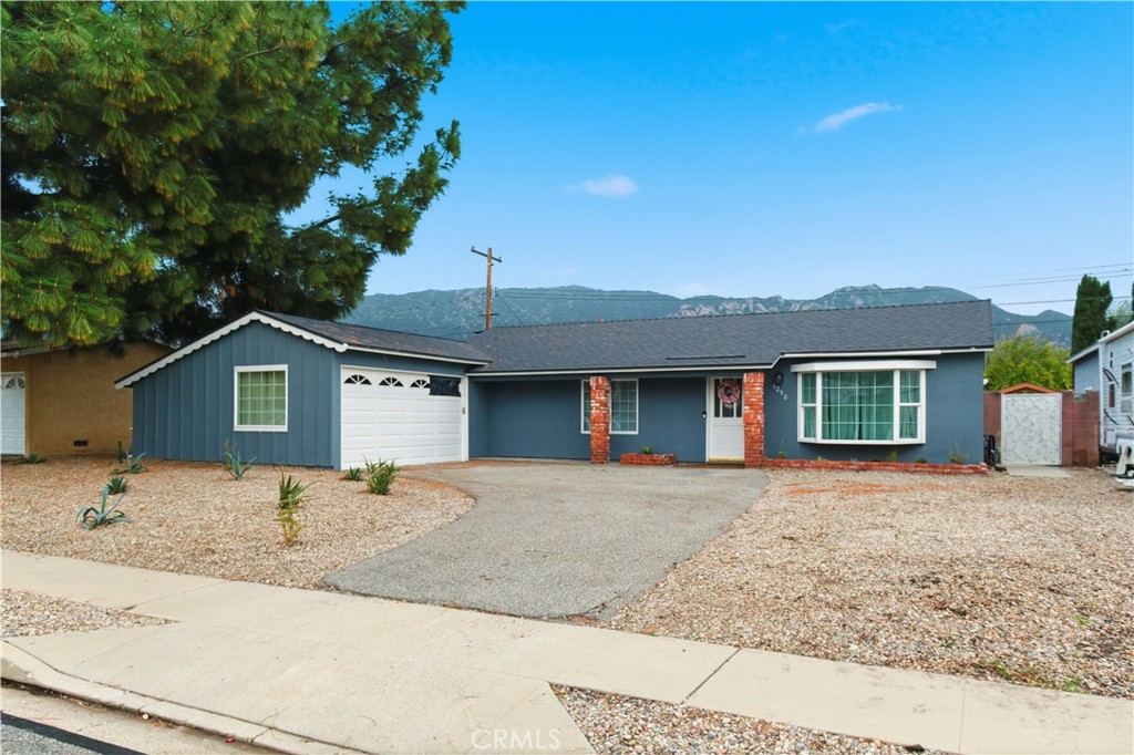 6290 Cynthia Street Simi Valley, CA 93063 - Photo 3 of 32 a front view of a house with a yard and garage