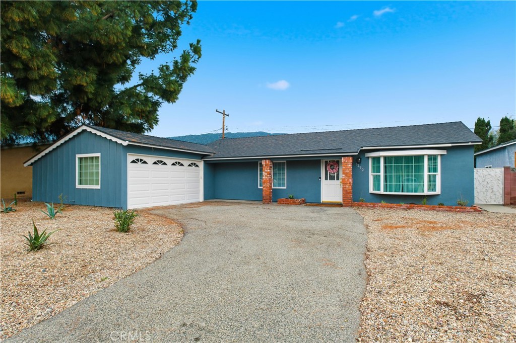 6290 Cynthia Street Simi Valley, CA 93063 - Photo 6 of 32 a front view of a house with a yard and garage
