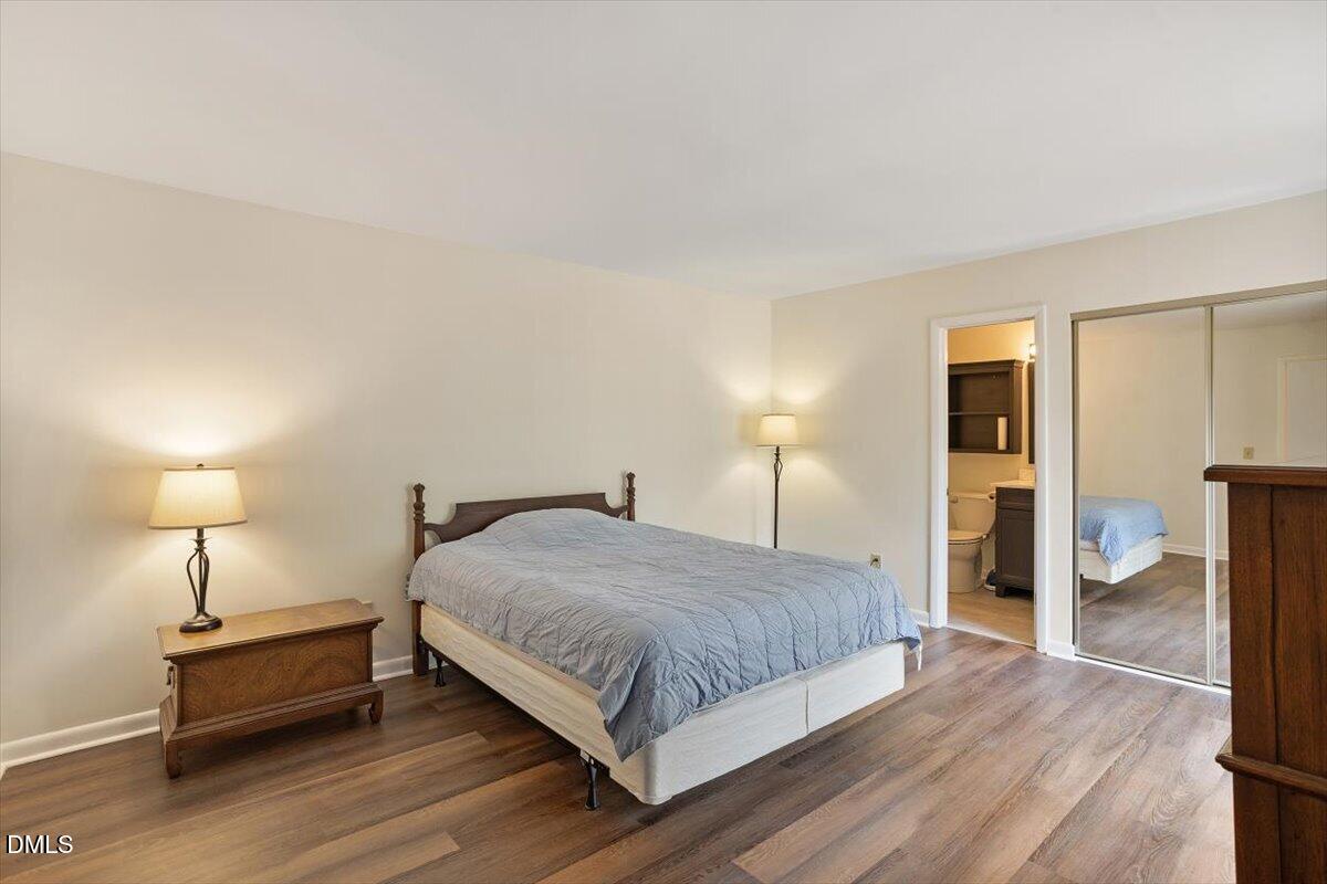 163 Springberry Lane Chapel Hill, NC 27517 - Photo 15 of 32 a bedroom with a bed and a lamp