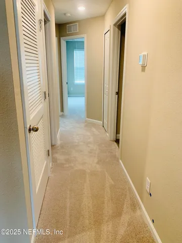 an empty room with closet and a bathroom