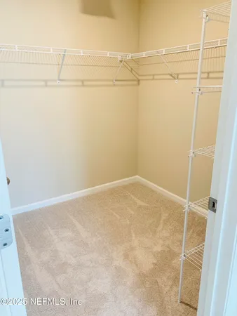a bathroom with a sink vanity granite tub and a mirror