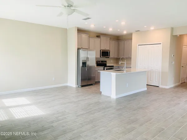 a kitchen with stainless steel appliances a refrigerator and a stove top oven