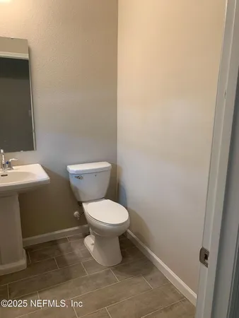 a white toilet sitting next to a white sink