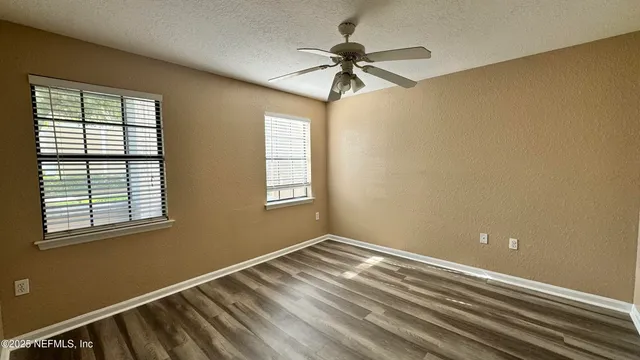 a view of room with window and ceiling fan