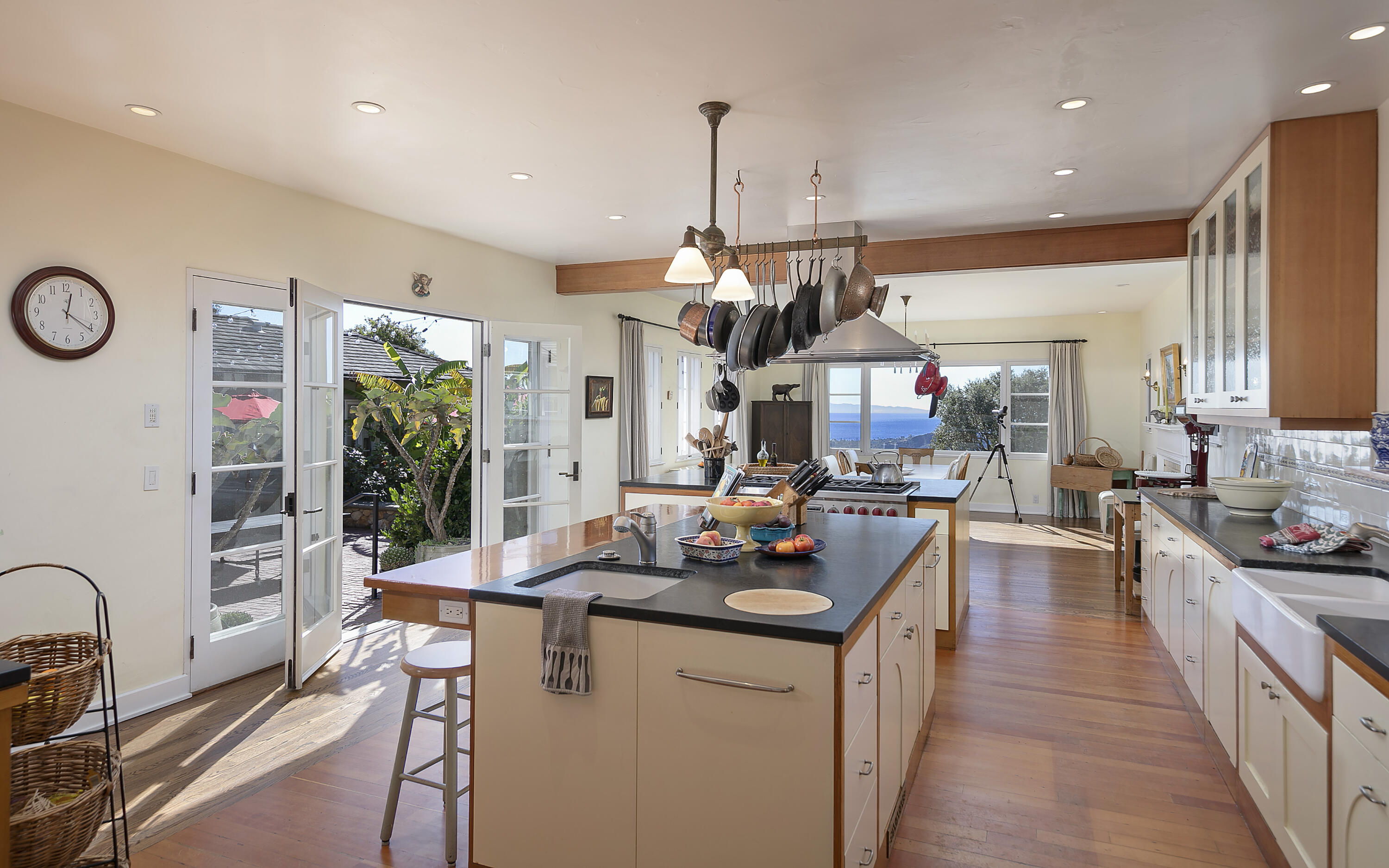 1138 Mission Ridge Road Santa Barbara, CA 93103 - Photo 24 of 54 a view of a kitchen with kitchen island stainless steel appliances a stove a sink a center island and living room view