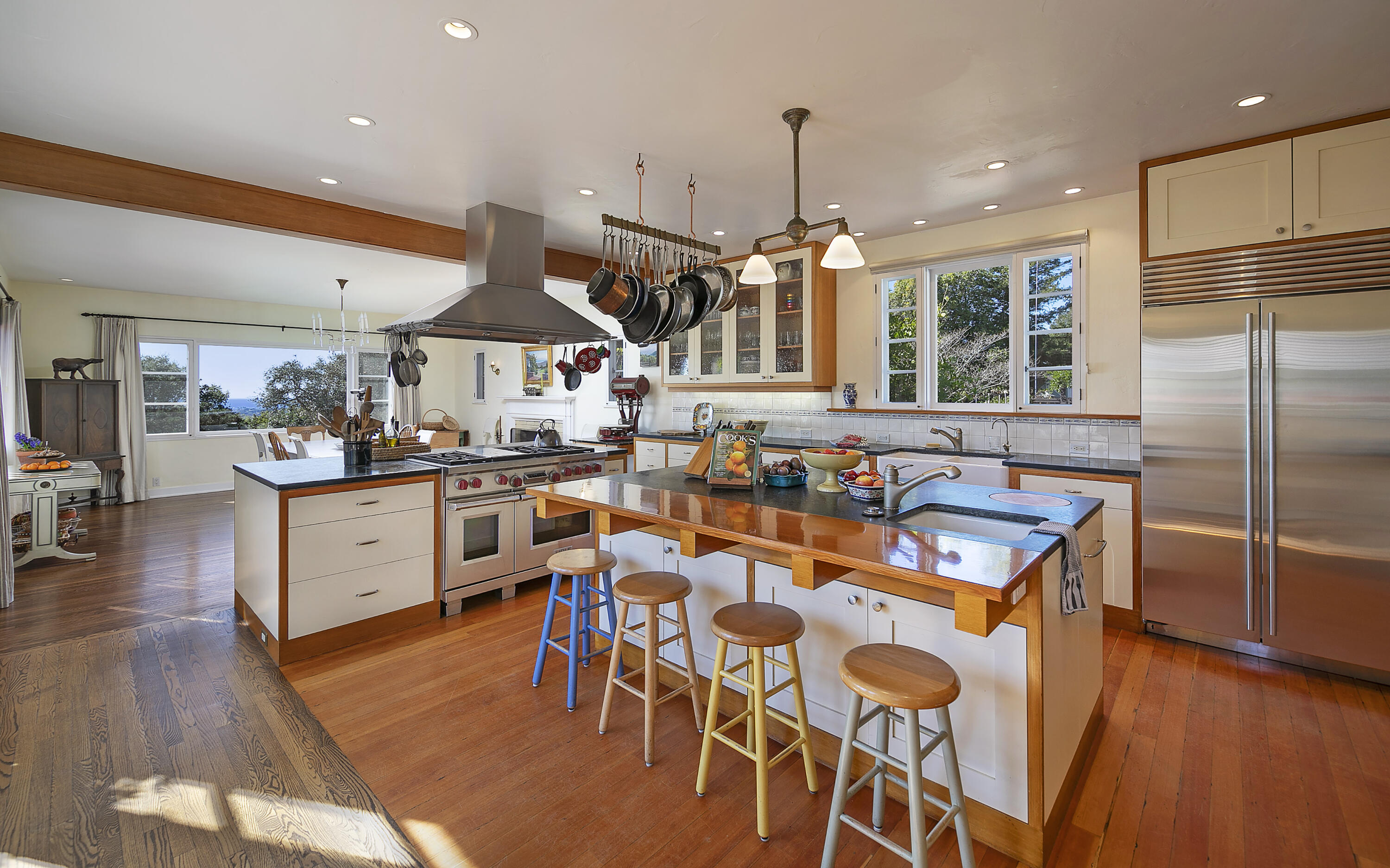 1138 Mission Ridge Road Santa Barbara, CA 93103 - Photo 25 of 54 a kitchen with stainless steel appliances granite countertop a refrigerator a stove top oven a dining table and chairs with wooden floor