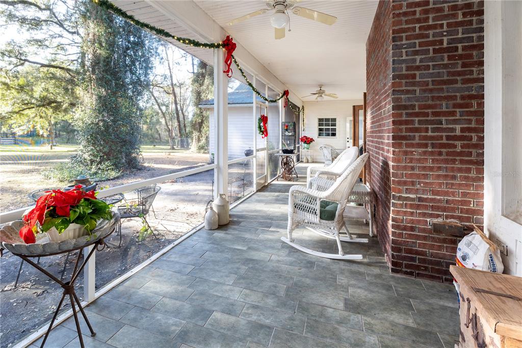 993 Cr 722 Webster Webster, FL 33597 - Photo 23 of 96 a view of a patio with a dining table and chairs