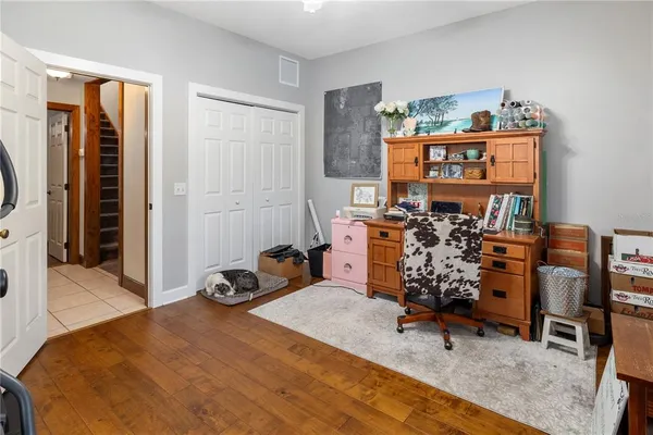 a living room with furniture fireplace and a large window
