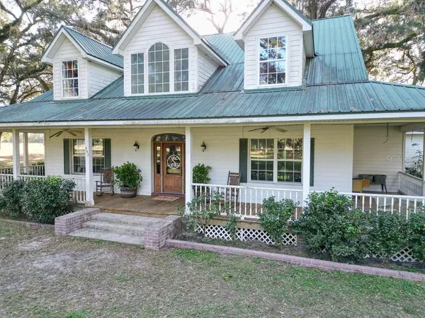 a front view of a house with a yard and porch