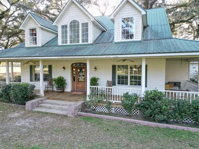 a front view of a house with a yard and porch