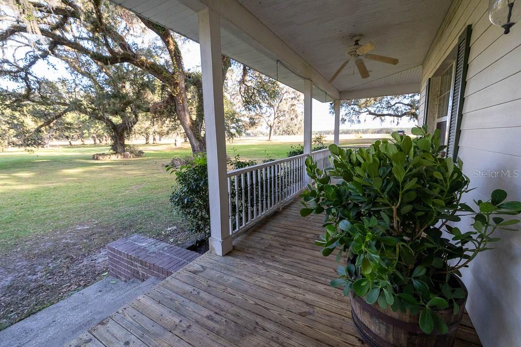 993 Cr 722 Webster Webster, FL 33597 - Photo 10 of 96 a view of a porch with wooden floor
