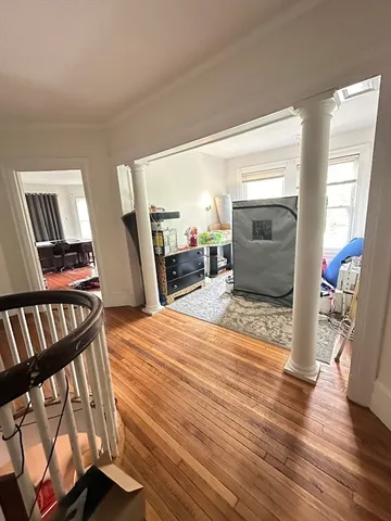 a bedroom with furniture and a wooden floor