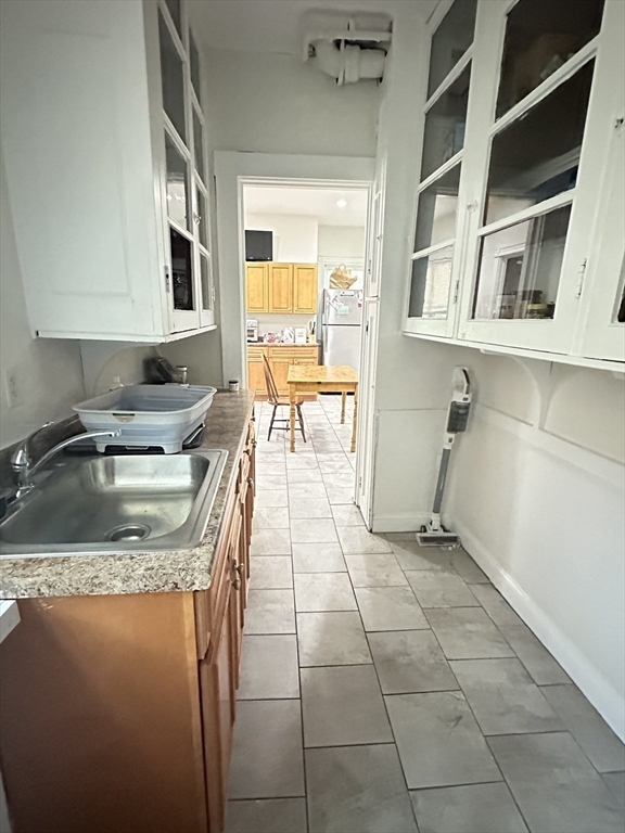 27 Orkney Road, Unit 1 Boston, MA 02135 - Photo 5 of 26 a kitchen with a sink a stove a microwave and cabinets