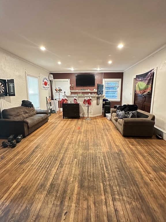 27 Orkney Road, Unit 1 Boston, MA 02135 - Photo 7 of 26 a large bedroom with a bed and wooden floor