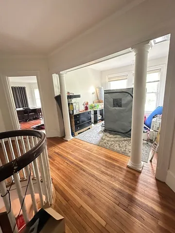 a bedroom with furniture and a wooden floor