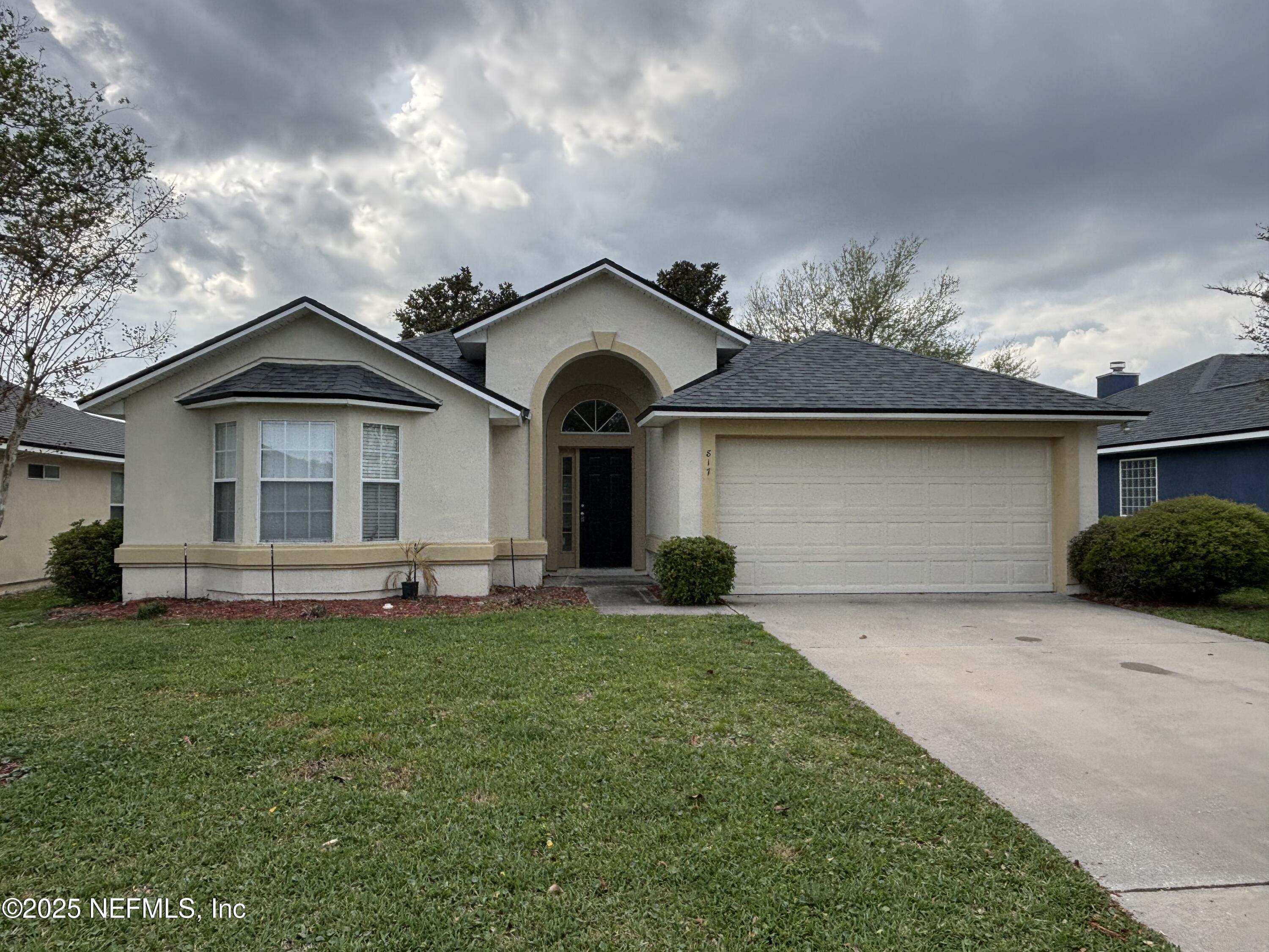 817 Oak Arbor Circle St. Augustine, FL 32084 - Photo 1 of 19 a front view of a house with a garden and yard
