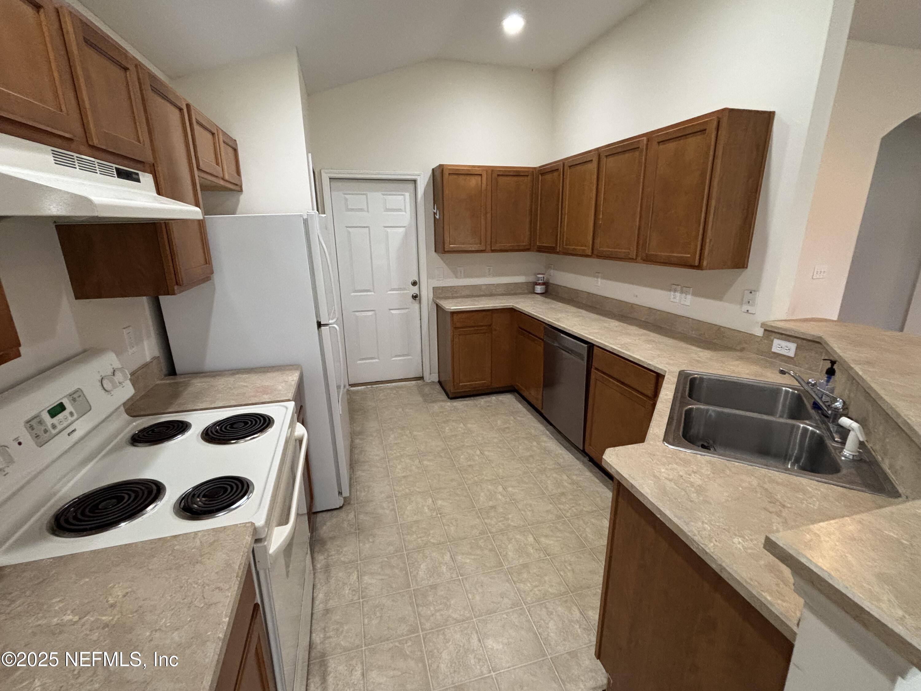 817 Oak Arbor Circle St. Augustine, FL 32084 - Photo 9 of 19 a kitchen with stainless steel appliances a sink a stove a microwave a sink and cabinets