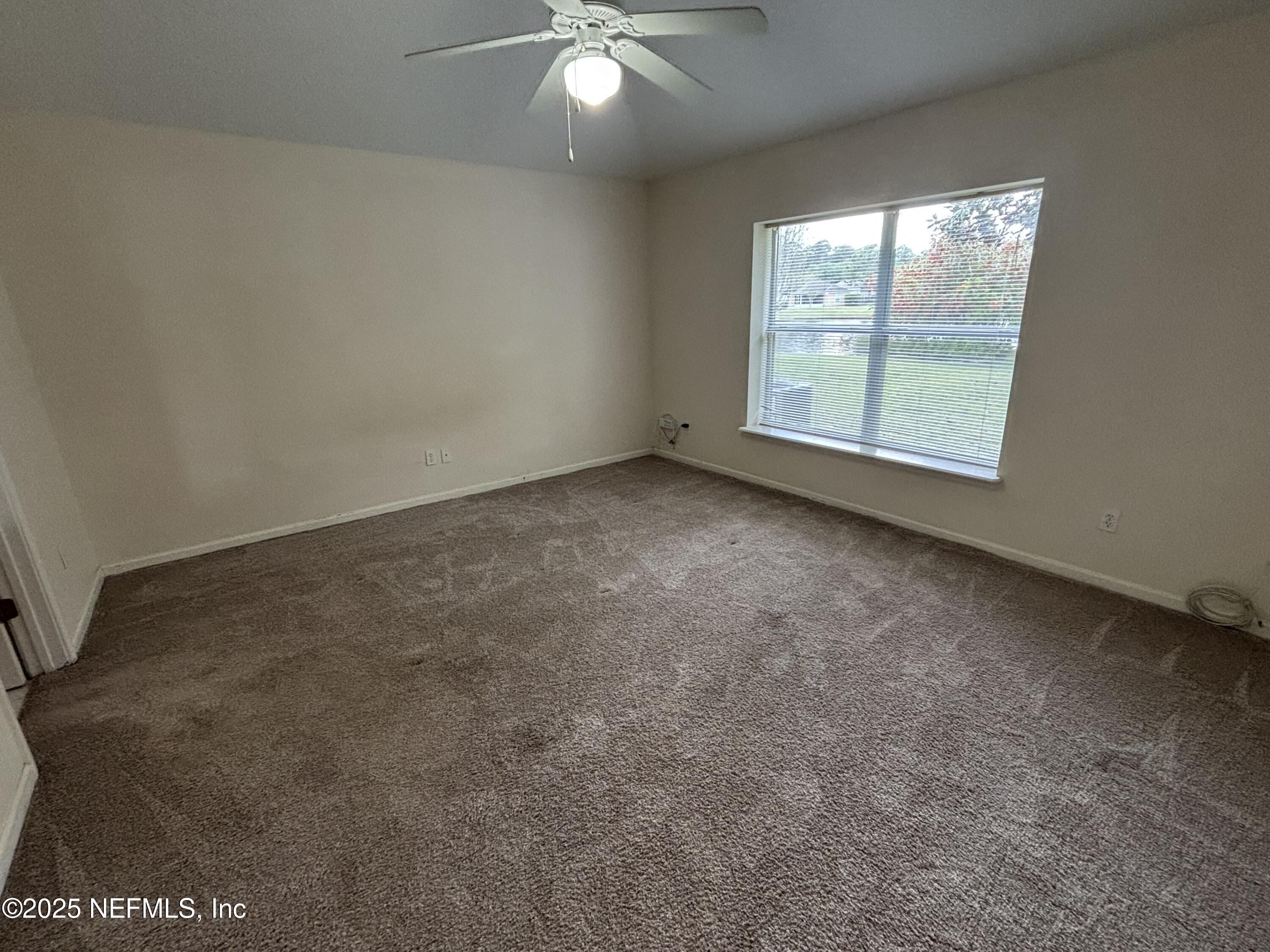 817 Oak Arbor Circle St. Augustine, FL 32084 - Photo 10 of 19 an empty room with windows and fan