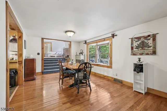 a view of a dining room with furniture and wooden floor