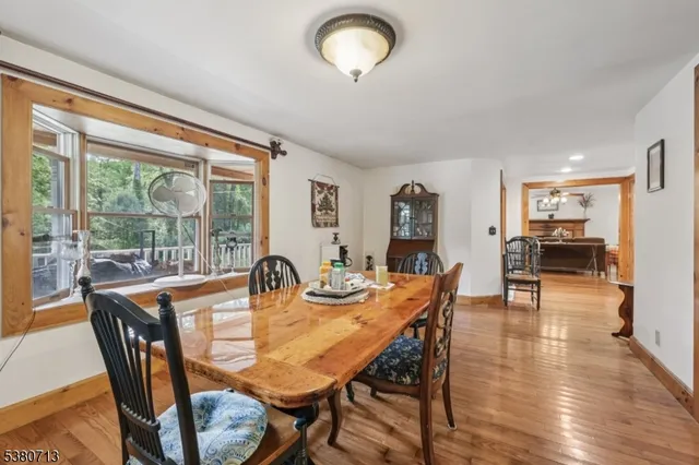 a dining room with furniture and a kitchen view