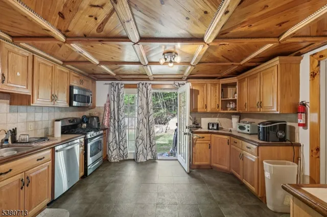 a open kitchen with white cabinets and stainless steel appliances