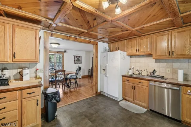 a kitchen with refrigerator cabinets and stove top oven