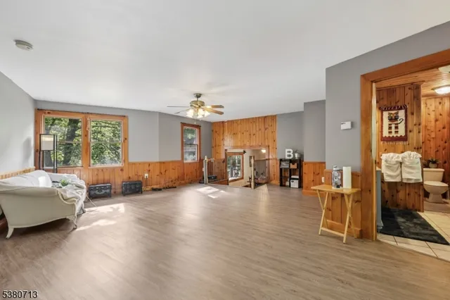 a bedroom with furniture and large windows