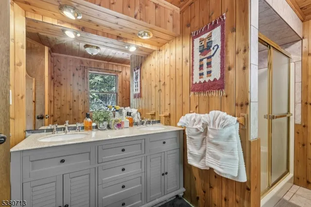 an empty room with chandelier fan and windows