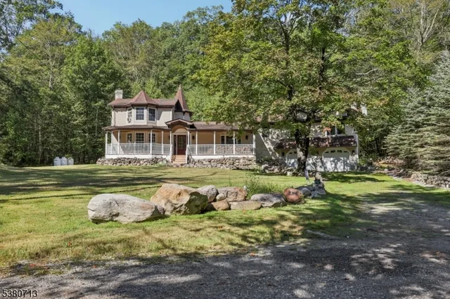 a front view of a house with a yard table and chairs