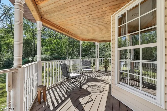 a view of balcony with wooden floor and fence
