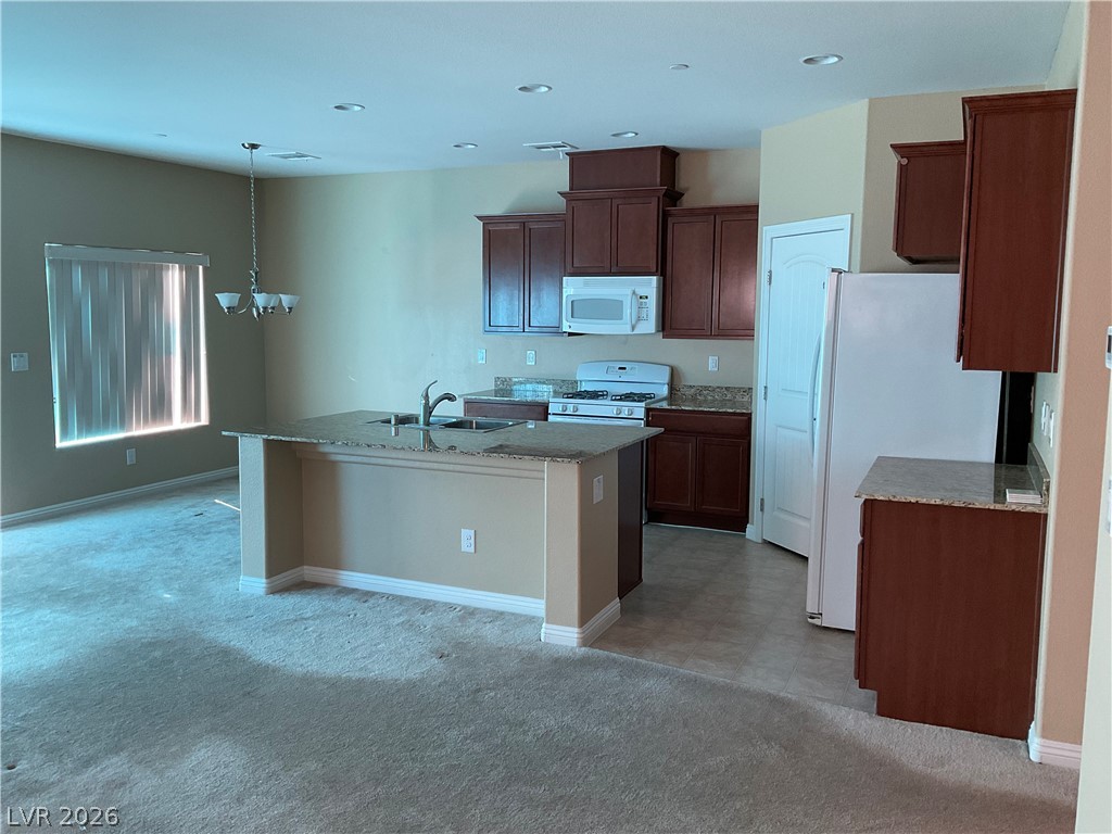 12 Jasmine Point Street Henderson, NV 89074 - Photo 2 of 15 An open-concept living space highlights a well-appointed kitchen island, perfect for entertaining.