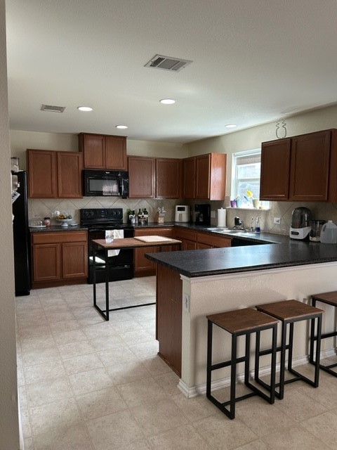 9008 Norwich Castle Austin, TX 78747 - Photo 11 of 26 a kitchen with stainless steel appliances granite countertop a stove a sink a microwave a refrigerator and a microwave