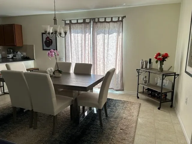 a view of a dining room with furniture and a window