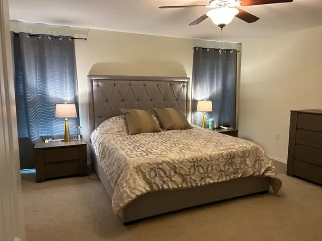 a bed sitting in a bedroom next to a lamp