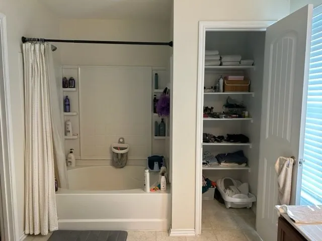 a bathroom with a bathtub and a window