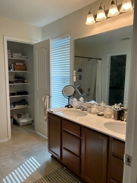 9008 Norwich Castle Austin, TX 78747 - Photo 21 of 26 a bathroom with a granite countertop sink and a mirror