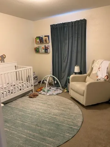 a view of a bedroom with furniture and window
