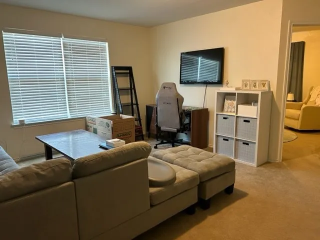 a bedroom with furniture and a flat screen tv