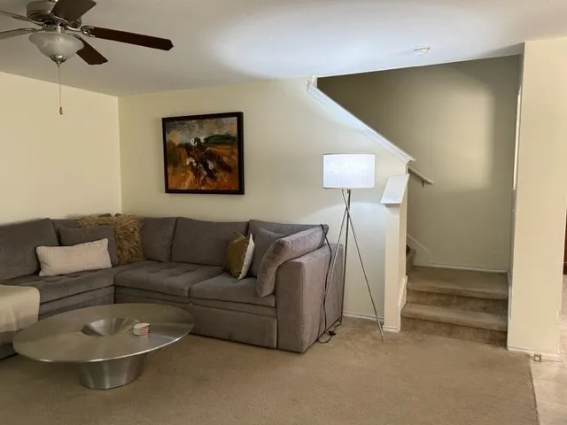 a living room with furniture and a lamp