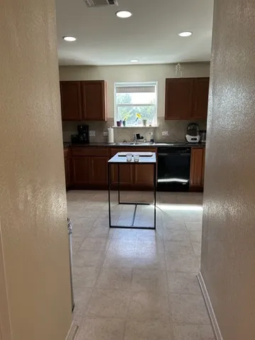 a kitchen with a refrigerator and a counter top space