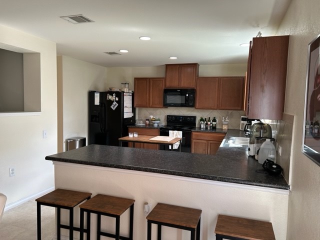 9008 Norwich Castle Austin, TX 78747 - Photo 8 of 26 a kitchen with stainless steel appliances granite countertop a sink refrigerator and microwave