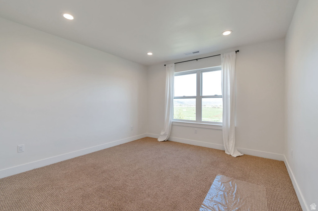 1820 West Farmhouse Flats Road Peoa, UT 84061 - Photo 29 of 79 Spacious room featuring a large window, recessed lighting, and carpeted flooring