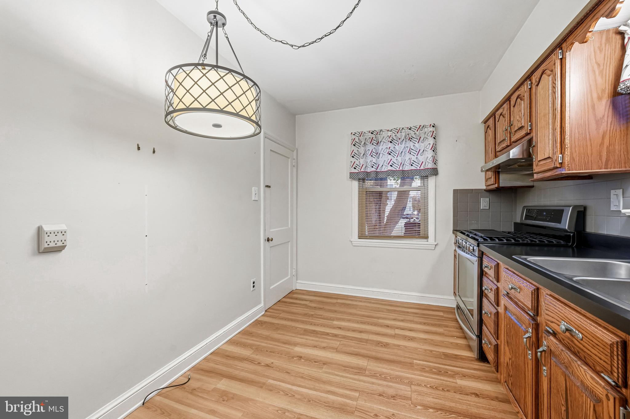 101 6th Avenue Mount Ephraim, NJ 08059 - Photo 12 of 27 a kitchen with stainless steel appliances granite countertop a stove a sink and dishwasher with wooden floor