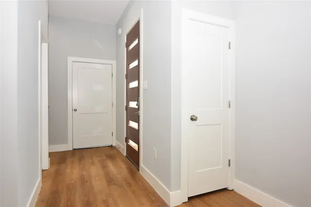 a view of a hallway with wooden floor
